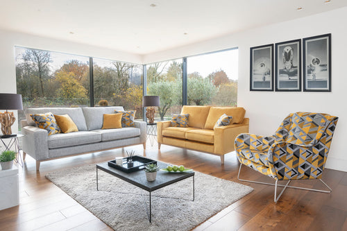 Grand sofa in fabric 0427, large scatter cushions in 0049, small scatter cushions in 0209, weathered oak plinth. 2 seater sofa in fabric 0209, small scatter cushions in 0049, weathered oak plinth. Accent chair in fabric 0049.